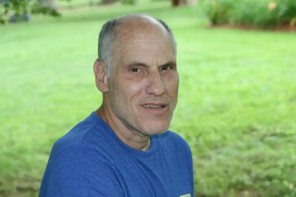 Rick Salk standing outdoors on a lawn in a blue t-shirt